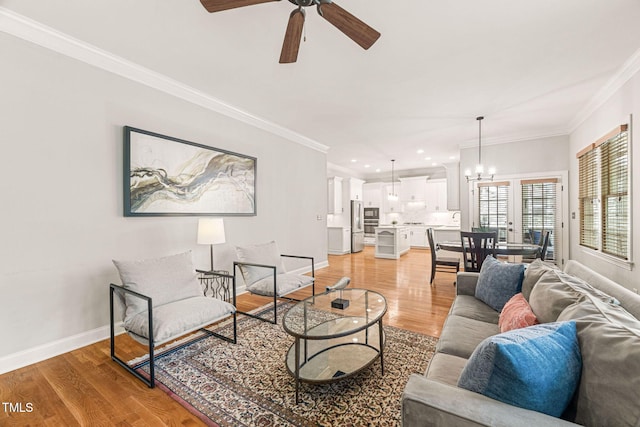 2728 Cameron Pond Dr, Cary, NC 27519 - living area with light wood finished floors, a ceiling fan, ornamental molding, baseboards, and a chandelier