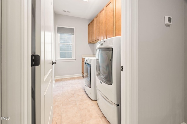 2728 Cameron Pond Dr, Cary, NC 27519 - washroom featuring cabinet space, light tile patterned flooring, baseboards, and washer and clothes dryer