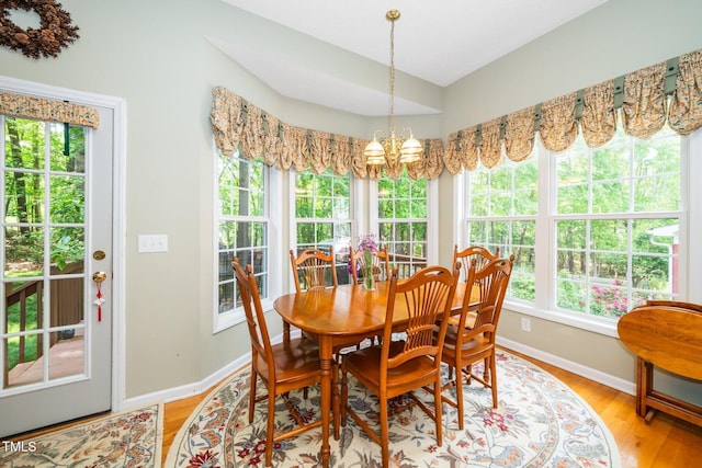 437 New Parkside Dr, Chapel Hill, NC 27516 - dining area featuring an inviting chandelier, baseboards, and light wood-type flooring