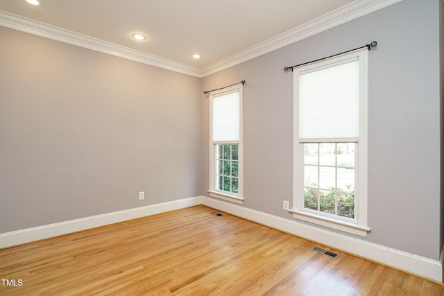 unfurnished room with visible vents, crown molding, baseboards, light wood finished floors, and recessed lighting