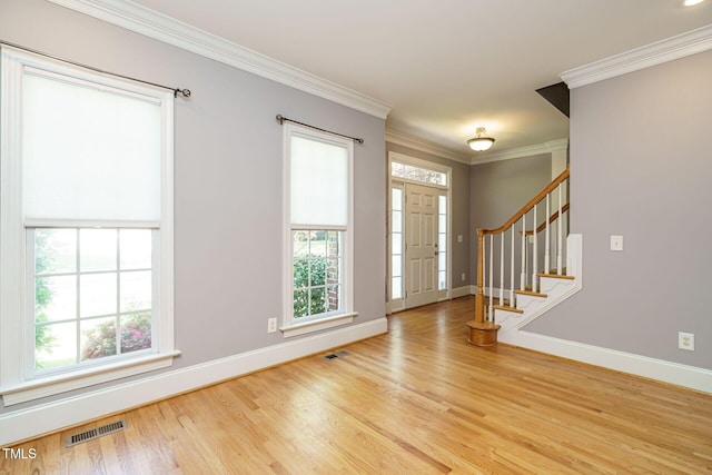 entryway with stairway, baseboards, wood finished floors, and visible vents