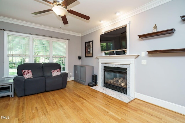 living area featuring ceiling fan, plenty of natural light, and wood finished floors