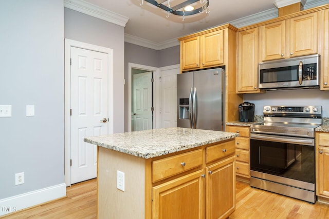 kitchen with ornamental molding, light stone countertops, light wood-style floors, baseboards, and appliances with stainless steel finishes