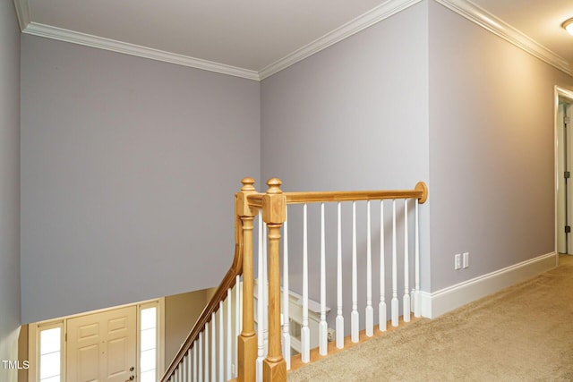 interior space featuring baseboards, ornamental molding, carpet flooring, and an upstairs landing
