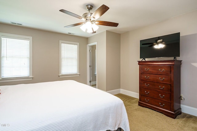 bedroom featuring visible vents, baseboards, and light carpet