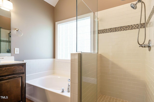full bath featuring vanity and a tile shower