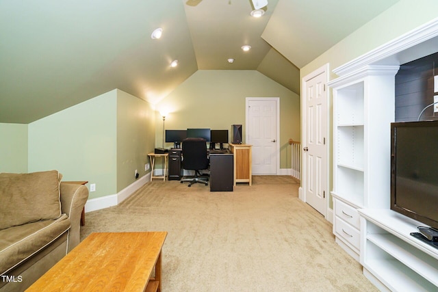 office space featuring baseboards, light carpet, and lofted ceiling