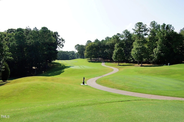view of home's community with a lawn and golf course view