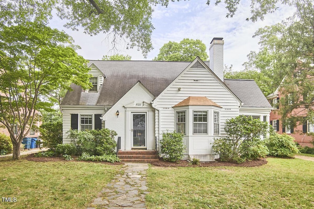 1104 Englewood Ave, Durham, NC 27701 - new england style home featuring a front yard, a chimney, and roof with shingles