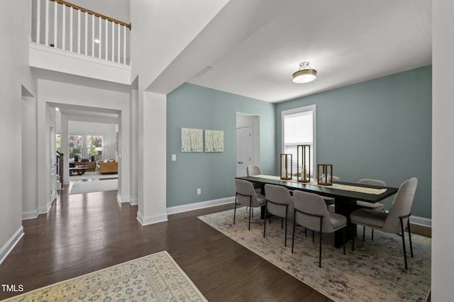 dining area with baseboards and wood finished floors