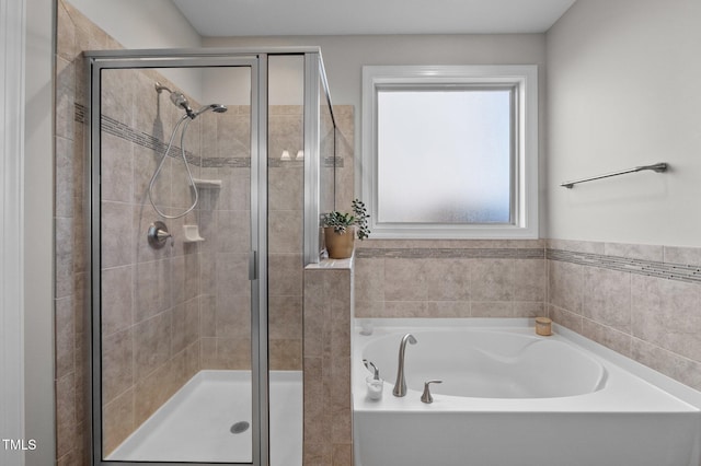 bathroom featuring a stall shower and a garden tub