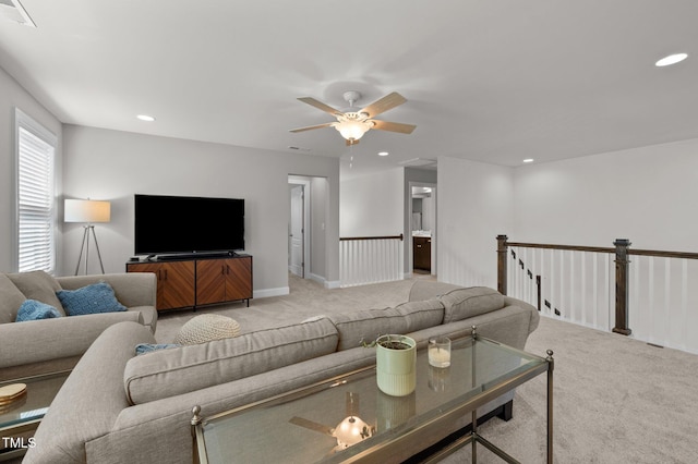living room featuring a ceiling fan, light colored carpet, recessed lighting, and visible vents
