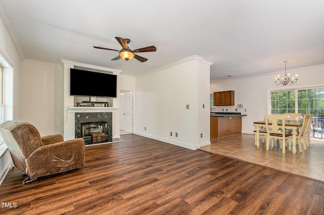1176 Stoney Mountain Rd, Rougemont, NC 27572 - living room featuring a ceiling fan, a chandelier, a fireplace, ornamental molding, and dark wood finished floors
