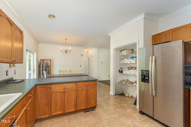 1176 Stoney Mountain Rd, Rougemont, NC 27572 - kitchen with stainless steel fridge with ice dispenser, a chandelier, a peninsula, ornamental molding, and brown cabinets