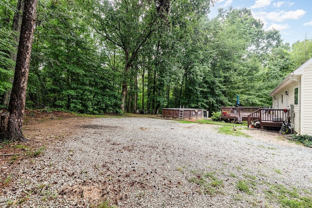 1176 Stoney Mountain Rd, Rougemont, NC 27572 - view of yard featuring a deck and a wooded view