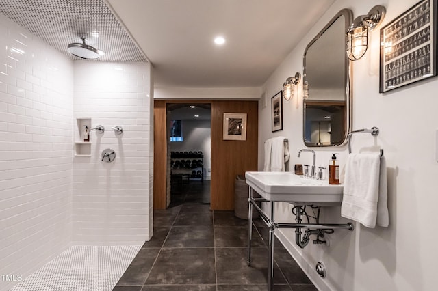 full bath with recessed lighting, tiled shower, tile patterned flooring, and a sink