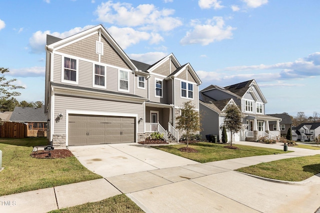 view of front facade with an attached garage, a front lawn, driveway, and stone siding