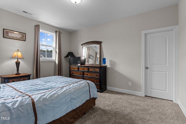 bedroom with visible vents, baseboards, and light carpet