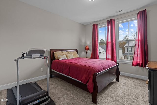 bedroom with baseboards, carpet flooring, and visible vents