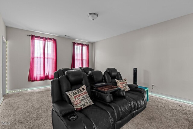 carpeted home theater with baseboards