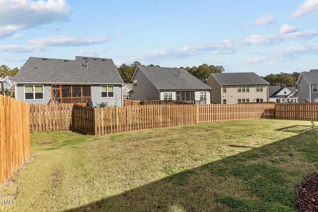 view of yard featuring a residential view and a fenced backyard