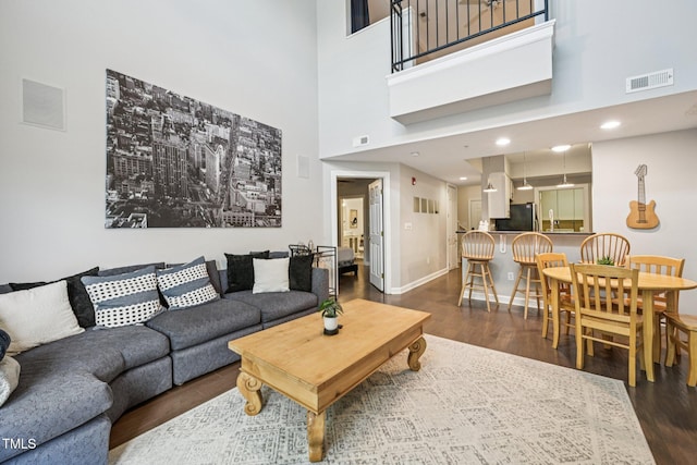 200 S Dawson St Unit 114, Raleigh, NC 27601 - living room featuring wood finished floors, a high ceiling, and recessed lighting