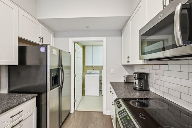 200 S Dawson St Unit 114, Raleigh, NC 27601 - kitchen with appliances with stainless steel finishes, washer / clothes dryer, backsplash, white cabinetry, and dark stone countertops