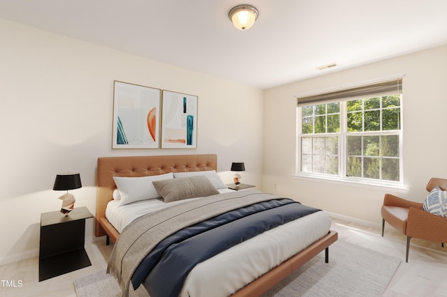 bedroom with baseboards and visible vents