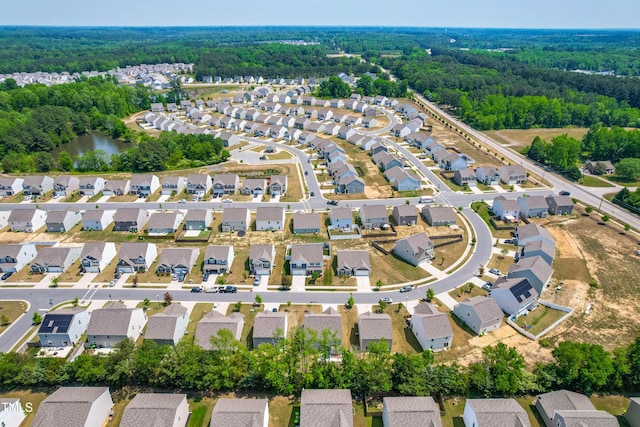 224 Brisk Dr, Zebulon, NC 27597 - aerial view of property and surrounding area with nearby suburban area and a heavily wooded area