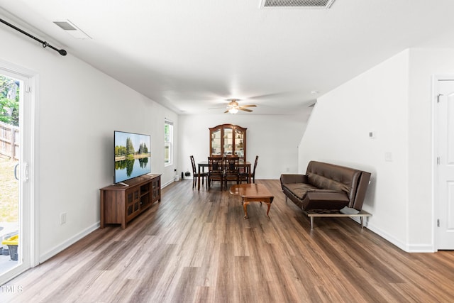 224 Brisk Dr, Zebulon, NC 27597 - living room with light wood finished floors, a ceiling fan, and baseboards