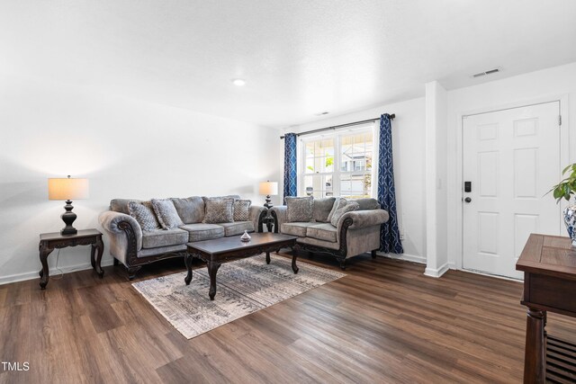 224 Brisk Dr, Zebulon, NC 27597 - living area featuring dark wood-type flooring and baseboards