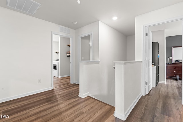 224 Brisk Dr, Zebulon, NC 27597 - hallway featuring wood finished floors, an upstairs landing, baseboards, washer / dryer, and recessed lighting