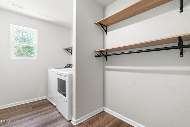 224 Brisk Dr, Zebulon, NC 27597 - laundry area with washer and dryer, wood finished floors, and baseboards