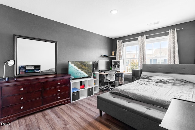 224 Brisk Dr, Zebulon, NC 27597 - bedroom with wood finished floors and a textured wall