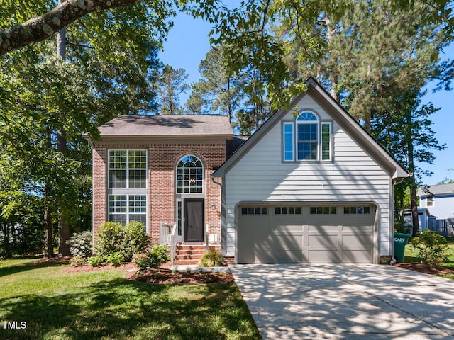 traditional home featuring brick siding, driveway, and a front yard