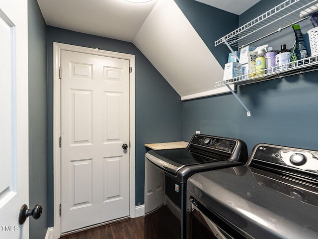 laundry area featuring washing machine and dryer, dark wood-style flooring, and baseboards