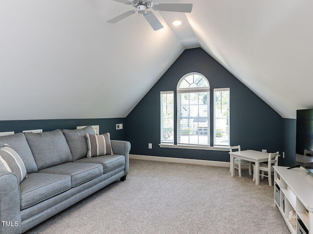carpeted living area with lofted ceiling, ceiling fan, and baseboards