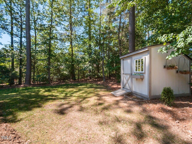 view of green lawn featuring a shed and an outdoor structure