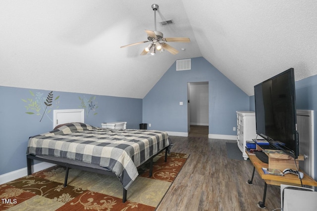 bedroom featuring wood finished floors, baseboards, lofted ceiling, and a ceiling fan