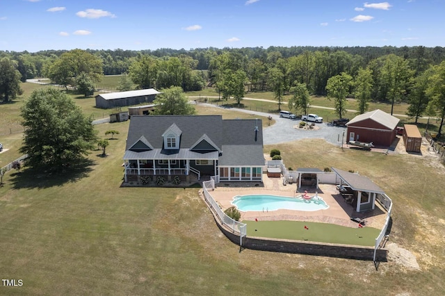 aerial view of property and surrounding area with a pool area