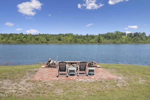 dock featuring a water view, a forest view, and a yard