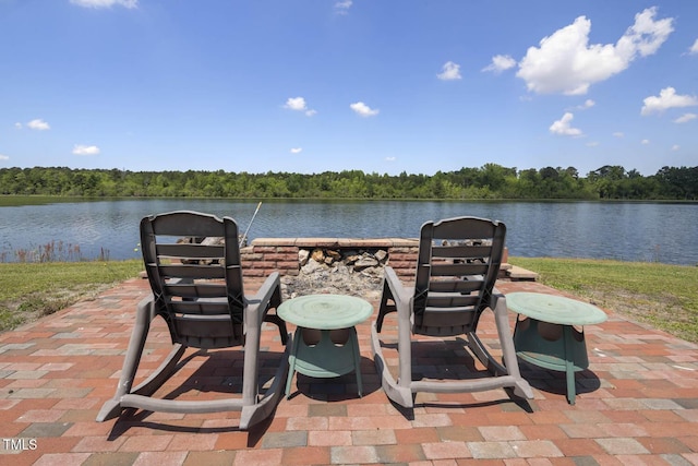 view of patio / terrace with a water view and a view of trees