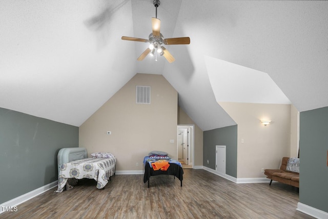 living area featuring wood finished floors, a ceiling fan, vaulted ceiling, and baseboards