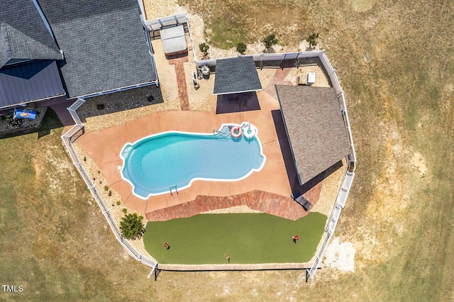 view of subject property with a pool area