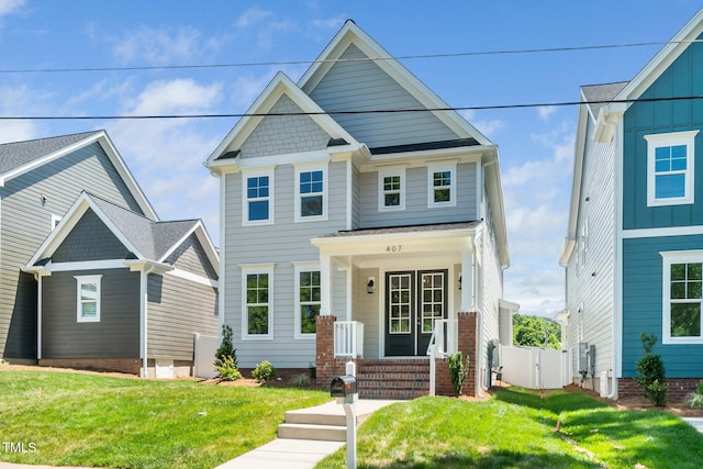 view of front facade with a front yard and a gate