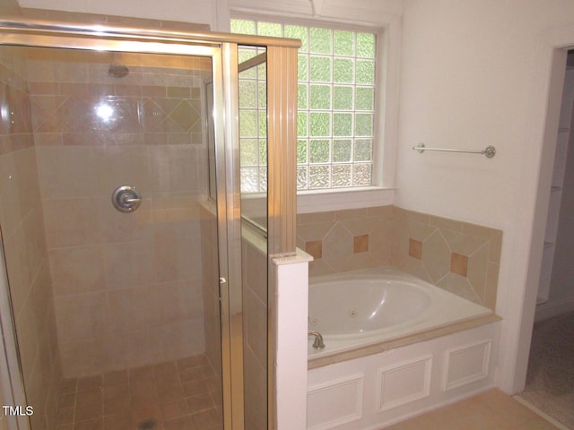 bathroom with a bath and a stall shower