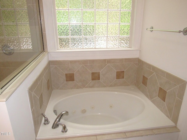 full bath with a tub with jets