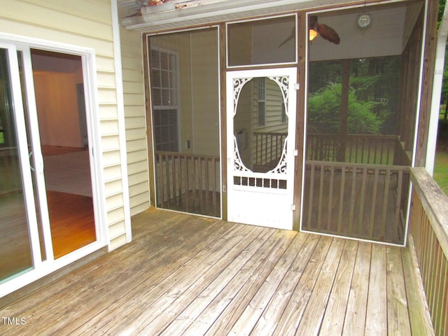 view of exterior entry with a wooden deck