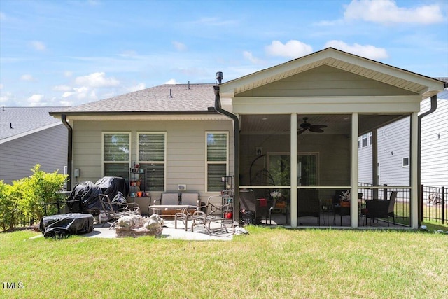 rear view of property with a lawn, a ceiling fan, a patio area, and fence