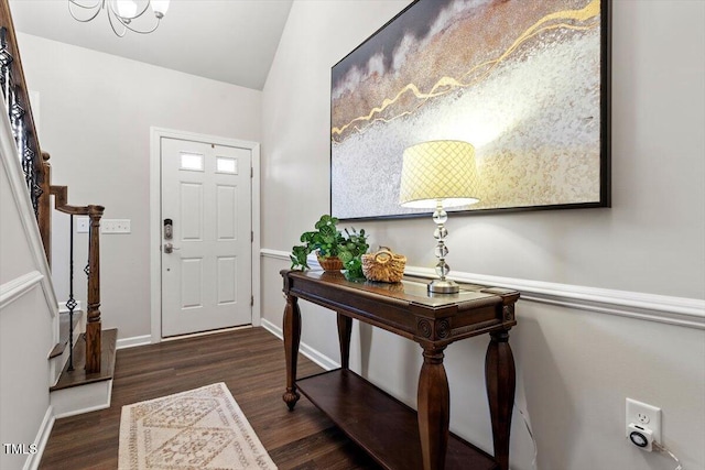 entryway with baseboards, wood finished floors, and stairway